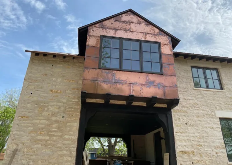 Copper metal panel facade on a stone building for Roof Repair in Hendersonville