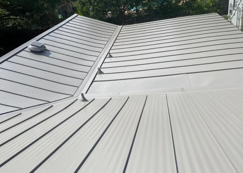 Solar attic fan installed on a metal roof for Roof Ventilation in Hendersonville